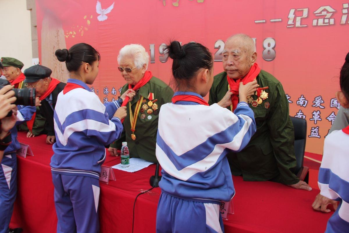將軍希望小學(xué)少先隊(duì)員向濟(jì)南戰(zhàn)役老戰(zhàn)士敬獻(xiàn)紅領(lǐng)巾