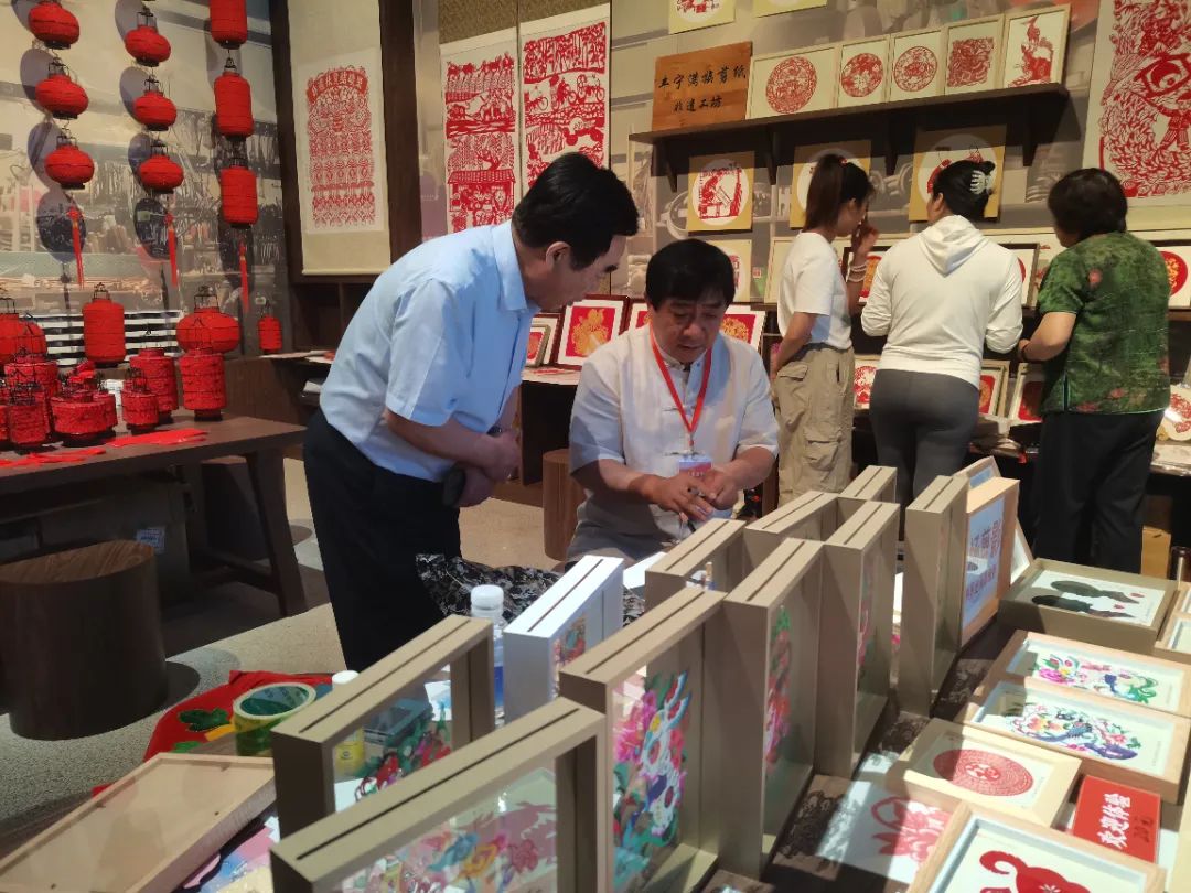 濟南市非物質(zhì)文化遺產(chǎn)保護協(xié)會會長、濟南益康總公司黨委書記董事長王忠本與剪紙技藝的非物質(zhì)文化遺產(chǎn)傳承人親切交流
